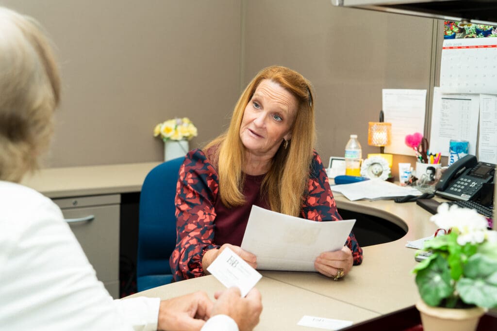 An E&B agent walking a client through their personal coverage at the office